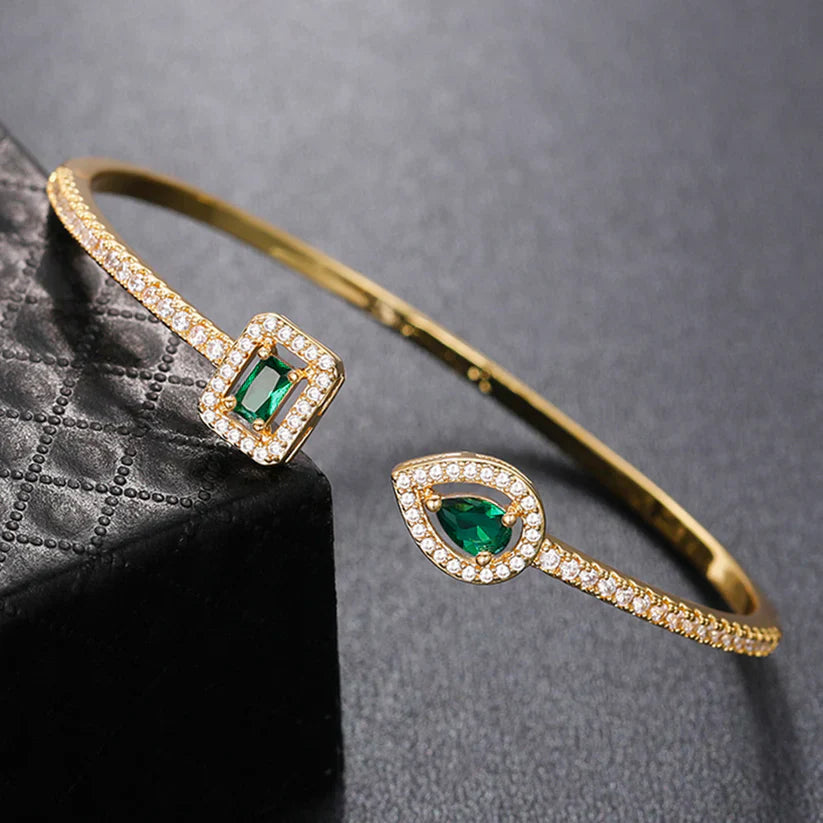 Heidi | Women’s open bangle bracelet with emerald stones and crystal accents