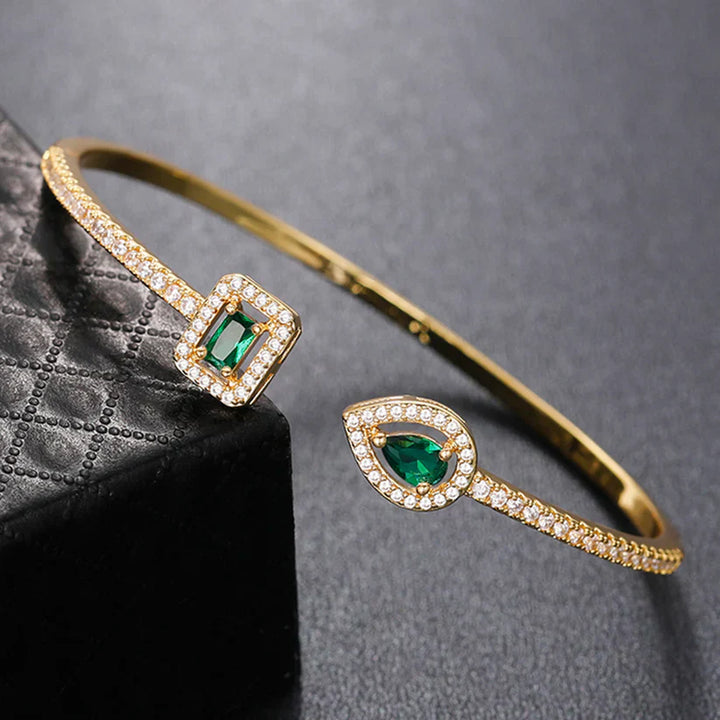 Heidi | Women’s open bangle bracelet with emerald stones and crystal accents