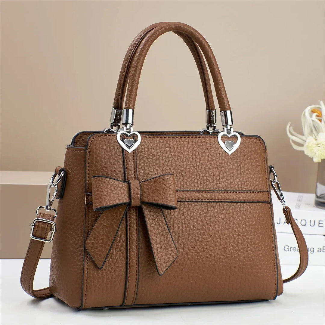Gabriela | Women’s bow handbag with heart accents