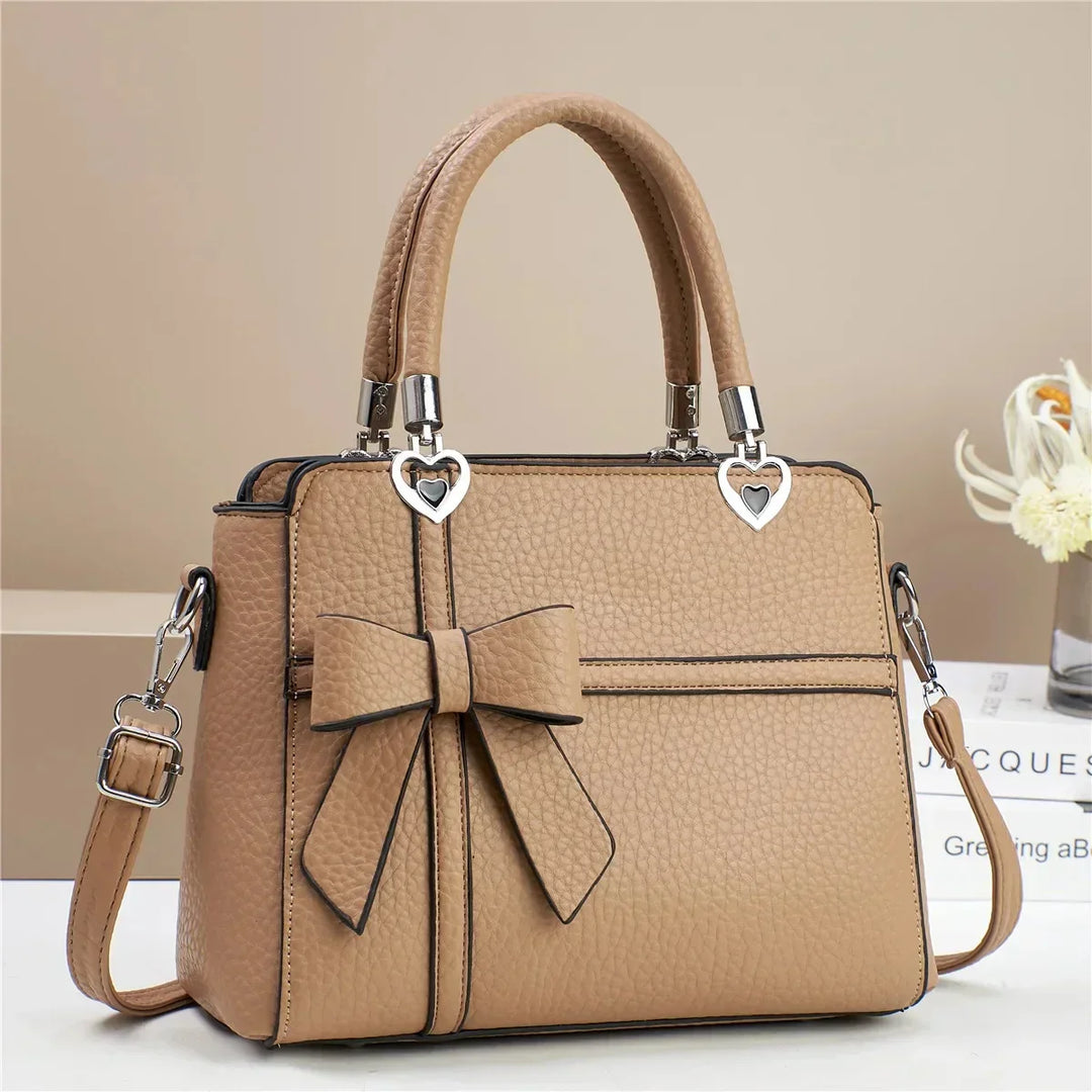 Gabriela | Women’s bow handbag with heart accents