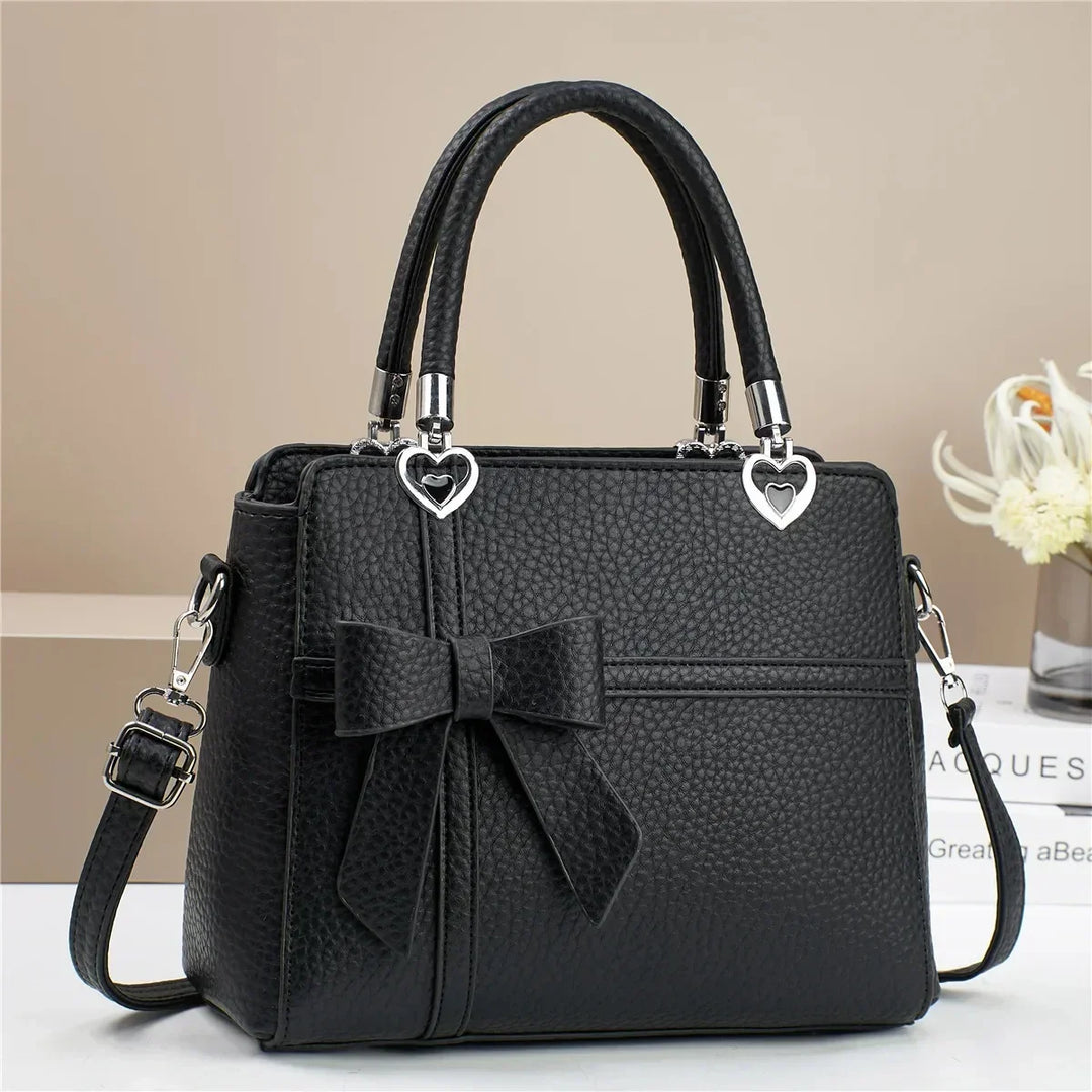 Gabriela | Women’s bow handbag with heart accents