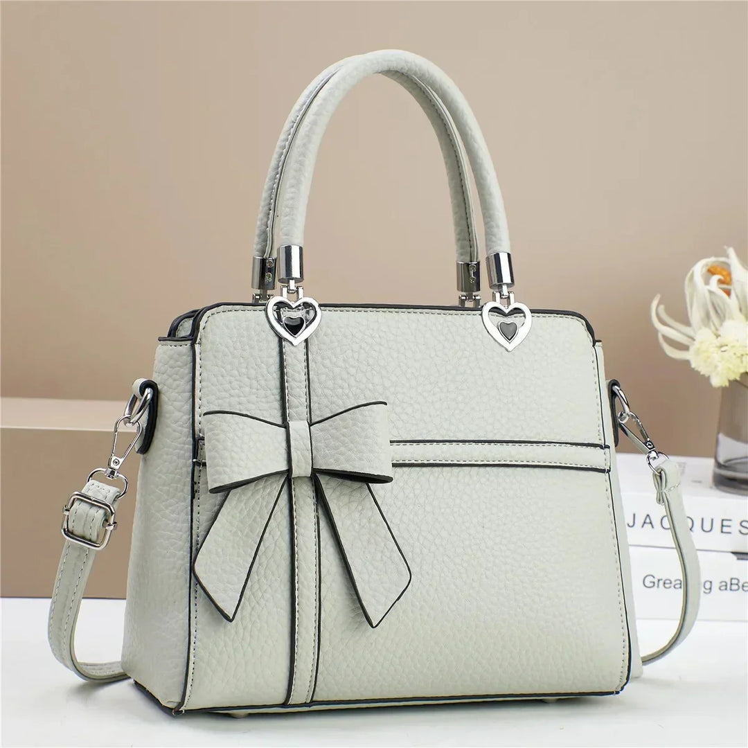 Gabriela | Women’s bow handbag with heart accents