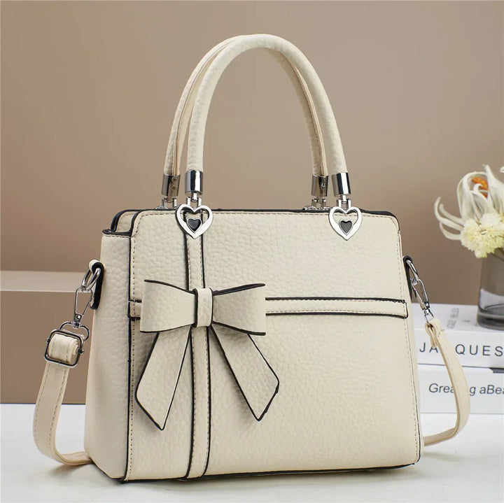 Gabriela | Women’s bow handbag with heart accents