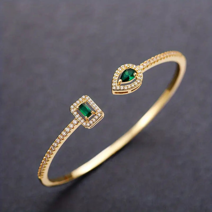 Heidi | Women’s open bangle bracelet with emerald stones and crystal accents